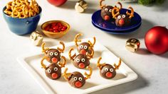 christmas treats are arranged on a plate with reindeer noses