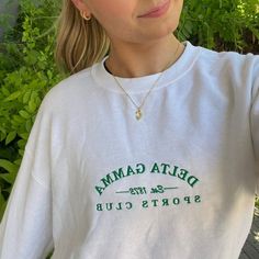 White crewneck, green embroidery, boyfriend fit. Our model is wearing size large (unisex). Size up for an oversized fit. 50% cotton, 50% polyester. Embroidery Boyfriend, Sorority Shirt Designs, Sorority Shirt, Green Sports, Green Embroidery, Sorority Designs