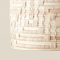 a woven lamp shade hanging from the ceiling