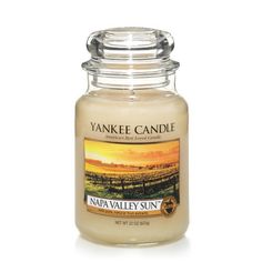 yankee candle with an image of a vineyard sunset on the front and back of it