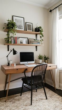 a desk with a computer, books and plants on the shelves above it in front of a window