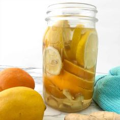 a jar filled with lemons, oranges and ginger