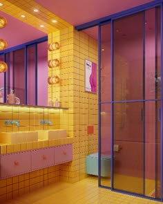 a bathroom with yellow and pink tiles on the walls