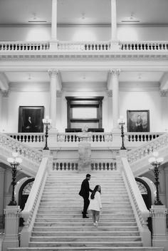 a man and woman standing on the steps of a building