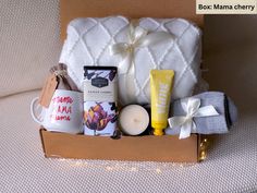 an open box containing candles, soaps and other items