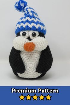 a crocheted penguin wearing a blue and white hat