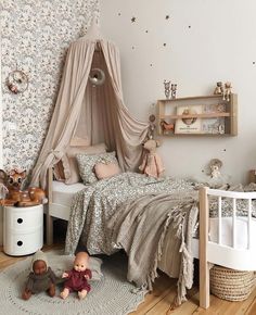 a small child's bedroom with a canopy bed and teddy bears on the floor