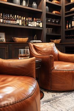 two brown leather chairs sitting next to each other in front of a shelf filled with bottles