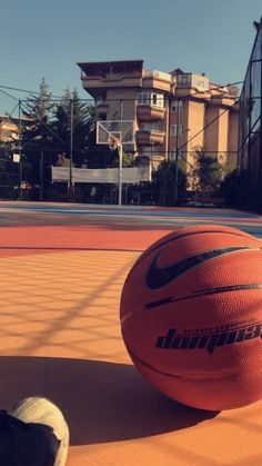 an orange basketball sitting on top of a court