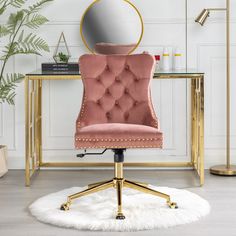 a pink velvet office chair in front of a gold desk with a mirror on it