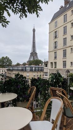 tables and chairs with the eiffel tower in the background