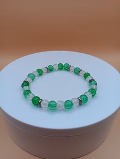 Green and white 6mm glass bead bracelet. It is very colorful and can make a nice St. Patrick's Day bracelet.  Bracelet is crafted with quality elastic stretch cord for the perfect fit. All items are made to order. They are shipped via United States Postal Service with a tracking number. Items will be shipped within 1 to 3 days except for holidays. Slight color variations may occur due to lighting and photo enlargement. If you have any questions, please don't hesitate to contact me. I will do my best to respond as soon as possible. Please click on the link below if you are interested in more bracelets from Craft My Heart Store.  https://www.etsy.com/shop/CraftMyHeartStore Also, follow Craft My Heart Store on social media and keep up with the latest sales and new listings. Instagram: Craft M Green Bracelets With Heart Beads For Gift, Green Bracelets With Colorful Glass Beads, Novelty Green Beaded Bracelets, Adjustable Green Heart-shaped Beaded Bracelets, St Patrick’s Day Bracelets, Holiday Bracelets, Glass Bead Bracelet, Glass Beaded Bracelets, Colorful Jewelry