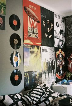 a bedroom with various records on the wall