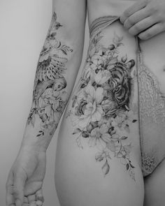 a woman's stomach with flowers and birds on it