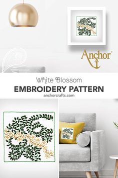 white blossom embroidery pattern with green leaves on the back and yellow pillows, in front of a