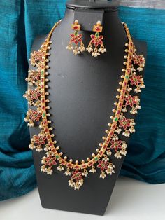 Stunning piece doesn't need any description 😊 this ethnic piece is set in traditional Ruby and green kemp stones and pearls. The matching earrings are also gold plated and 1.5 inches long . The necklace is 20 inches long with adjustable dori .  If you are looking for a high quality jewelry set then this one is for you ! The necklace is stunning in real , pictures are failing to capture its beauty.  This is as close as you can get to a real thing in imitation jewelry. Indian Jewelry Gold, Long Necklace Set, South Indian Jewelry, Gold Jewelry Indian, Stone Gold, Wedding Jewelry Sets, Indian Jewellery, Jewelry Gold, High Quality Jewelry