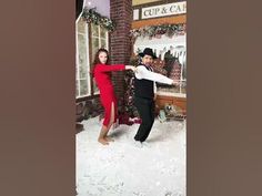 a man and woman dancing in the snow