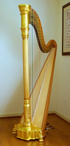 a golden harp sitting on top of a hard wood floor