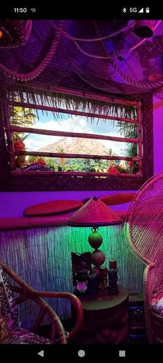 two wicker chairs sitting in front of a window