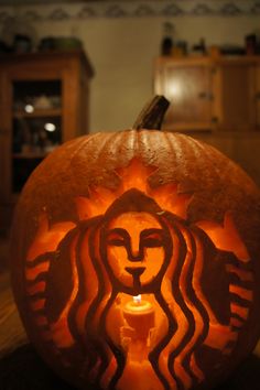 a pumpkin carved to look like a starbucks coffee cup