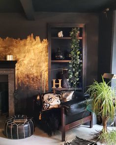 a living room filled with furniture and a fire place next to a wall covered in gold paint