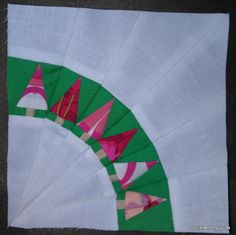 a green and white piece of cloth with designs on it