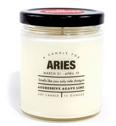 an open jar of candles sitting on a white surface with a black lid that reads aris march 21 - apr 19