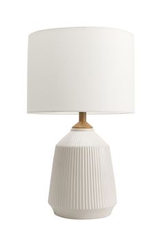 a white table lamp with a beige shade on the base and a white drum light behind it