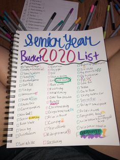 someone is holding up a school year bucket list