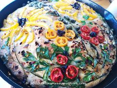 a pizza with tomatoes and other toppings in a pan