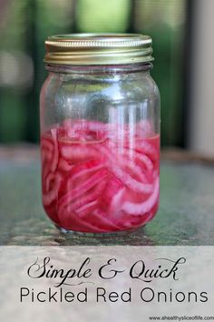 a mason jar filled with pickled red onions