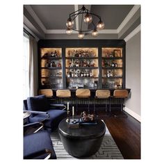 a living room filled with furniture and a bar