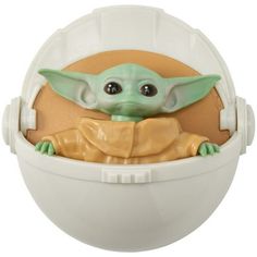 the baby yoda toy is in a plastic container