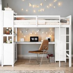 a white bunk bed sitting next to a desk