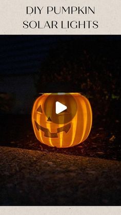 an orange pumpkin sitting on top of a sidewalk with the words diy pumpkin solar lights