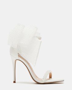 a woman's white high heeled sandal with ruffles on the side