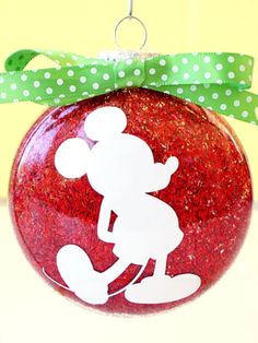 a red ornament with a white mickey mouse design on it's side