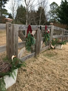 a wooden fence with wreaths hanging on it