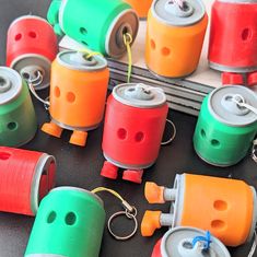 many different colored canisters sitting on top of a black table next to each other