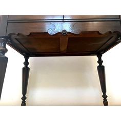 an antique wooden desk with two drawers