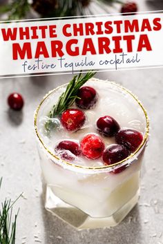 a white christmas margarita with cherries and rosemary garnish