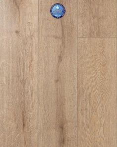 a wooden floor with a blue and white sticker on it