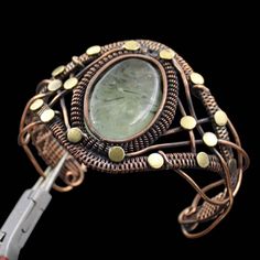 Prehnite Bangle Copper Wire Wrapped Cuff Bracelet Wire Wrap Bangle Prehnite Cuff Bracelet Handmade Jewelry Wire Wrap Jewelry Gemstone Bangle Main Stone - Prehnite Bangle Length - 2.50 - 2.75" Inches (Adjustable) Bangle Width - 5.00 CM Metal - Copper Copper Has Been Used For Jewelry Making For Thousands Of Years, Dating Back To Ancient Civilizations Such As The Egyptians, Romans, And Aztecs. Copper Was Valued For Its Beauty, Versatility, And Durability, And Was Often Used To Make Everything From Jewelry And Coins To Cookware And Tools. In Addition To Its Historical Significance, Copper Jewelry Also Offers Several Benefits. Copper Is A Natural Conductor Of Heat And Electricity, Which Makes It Ideal For Energy Healing And Therapeutic Purposes. Wearing Copper Jewelry Is Believed To Have Variou Handmade Jewelry Wire, Wire Wrapped Bangles, Bijoux Fil Aluminium, Wire Wrap Jewelry, Cuff Bracelets Handmade, Gemstone Bangle, Wrap Jewelry, Jewelry Wire, Adjustable Bangle