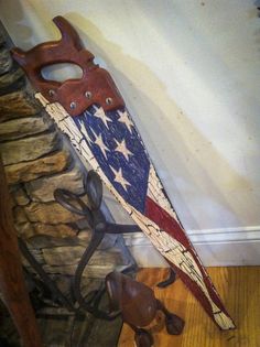 a pair of scissors sitting on top of an american flag shaped piece of wood next to a fire hydrant