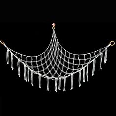 a white net with tassels hanging from it's sides on a black background