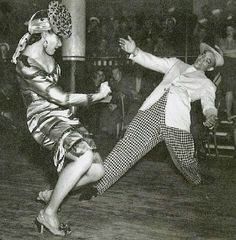 an old photo of two people dancing