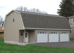 a two car garage sits in the middle of a yard