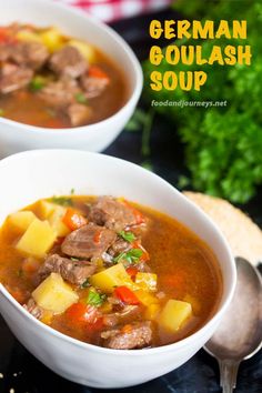 two bowls of german goulash soup on a table