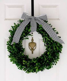 a white door with a black and white striped ribbon hanging from it's side