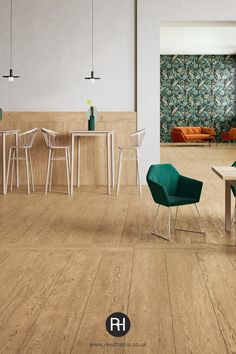 an empty room with chairs and tables on the floor in front of a wallpapered wall